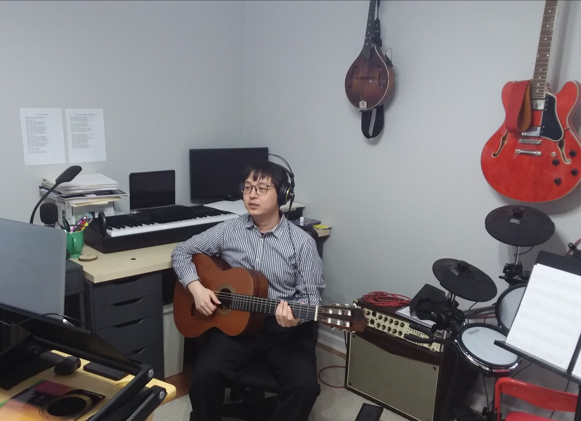 Professor Sungmin Shin teaches a guitar lesson through his computer at his home office. Photo supplied by Professor Sungmin Shin